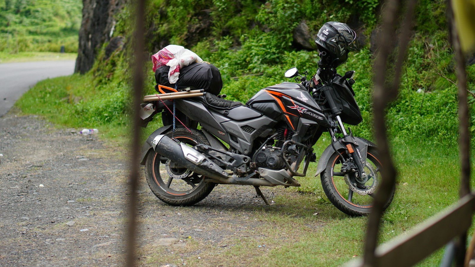 Loaded touring motorcycle parked on a rural road before a journey