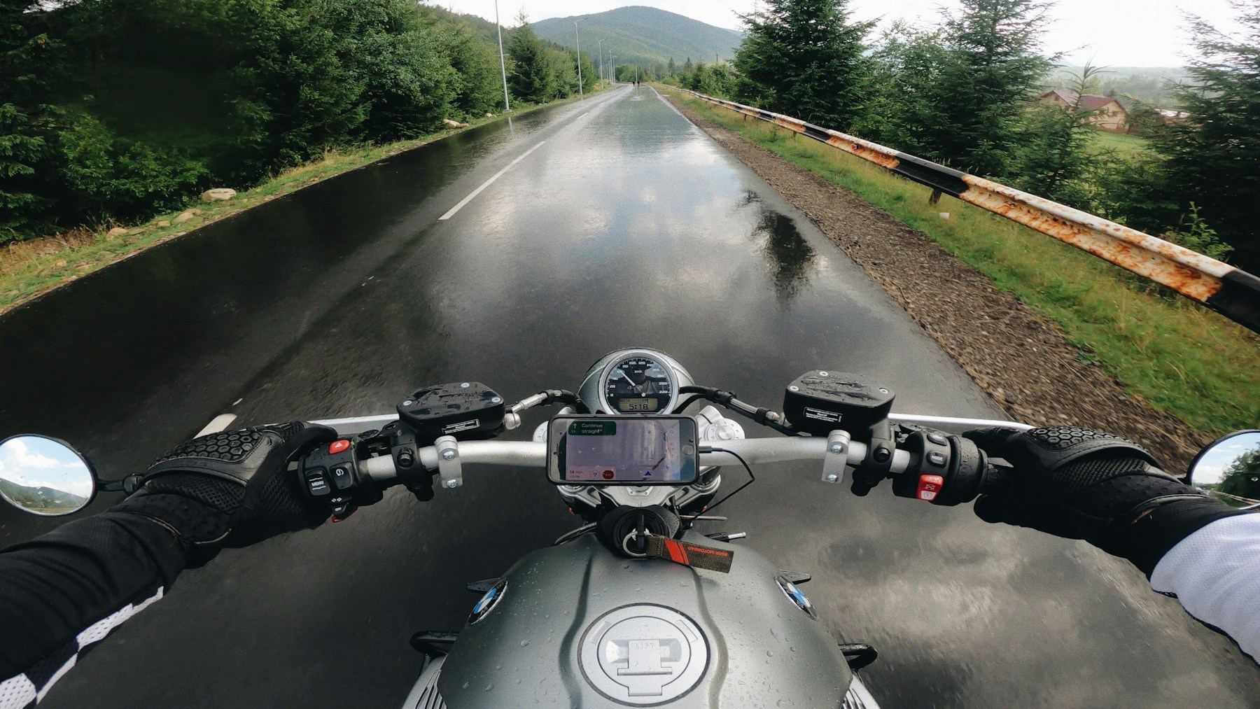 Rider view from a motorcycle on a wet mountain road