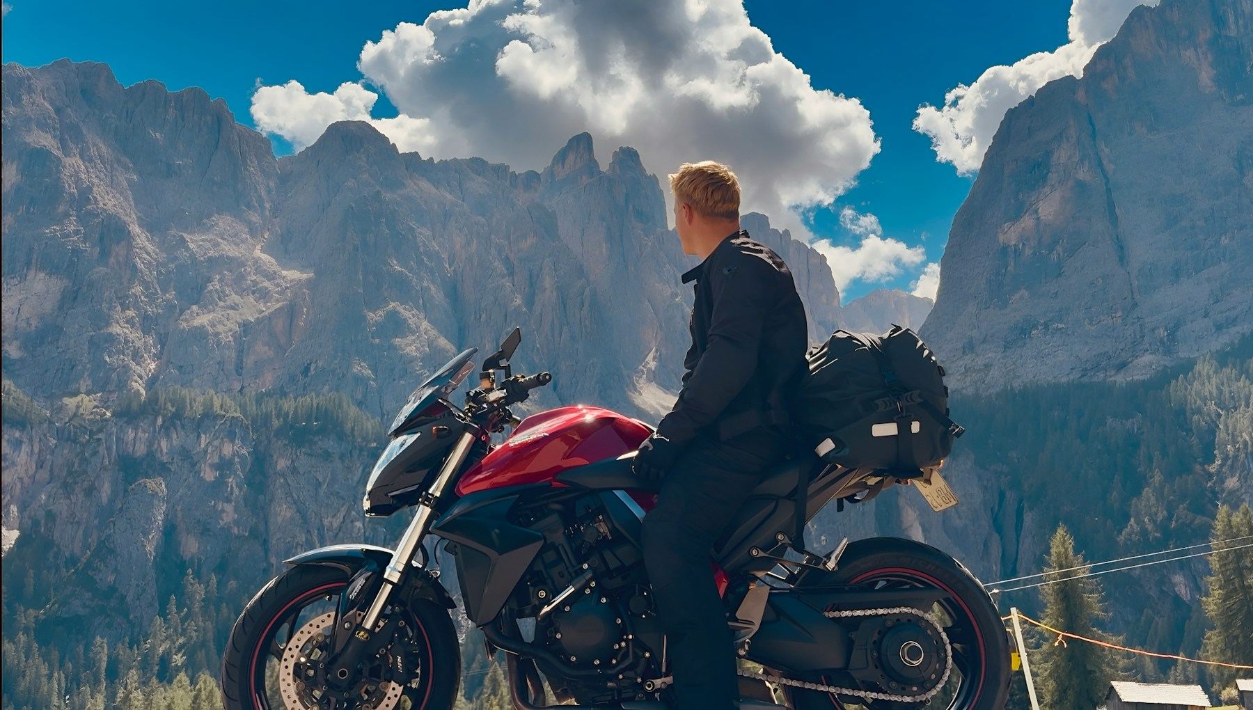 Motorcyclist overlooking the Dolomites near Corvara, Italy